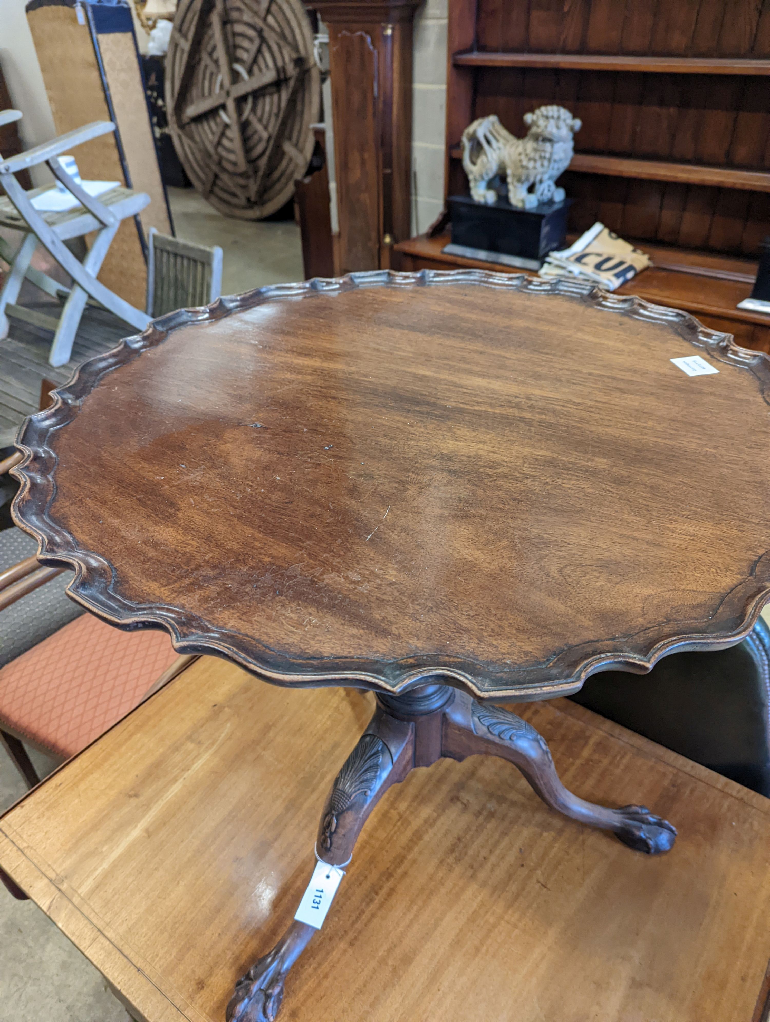 A George III style circular mahogany tripod table, with piecrust top and claw and ball feet, diameter 75cm, height 70cm